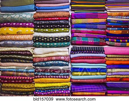 Close up of piles of multicolor fabrics View Large Photo Image Stock Photo - Close up of piles of multicolor fabrics. Fotosearch