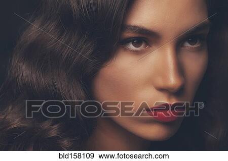 Stock Photo - Close up of serious glamorous woman. Fotosearch