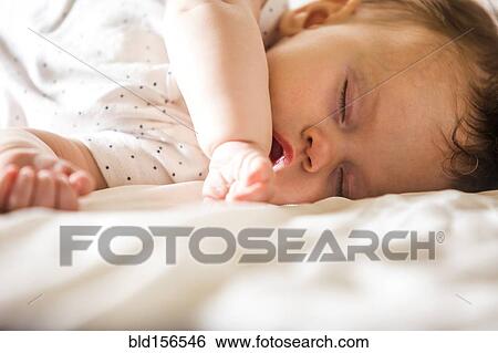 Stock Photograph - Close up of sleeping Caucasian baby girl. Fotosearch