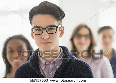 Stock Image - Close up of smiling businessman in office. Fotosearch