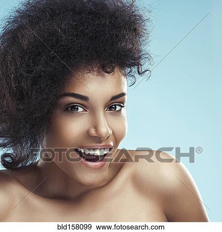 Stock Photo - Close up of surprised woman with curly hair. Fotosearch
