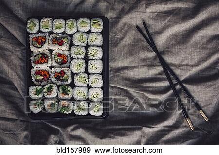 Stock Photo - Close up of tray of sushi rolls. Fotosearch