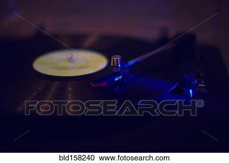 Stock Image - Close up of turntable playing vinyl record. Fotosearch