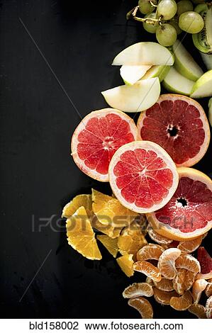 Close up of variety of sliced fruit View Large Photo Image Stock Image - Close up of variety of sliced fruit. Fotosearch