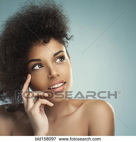 Stock Photo - Close up of woman with curly hair thinking. Fotosearch