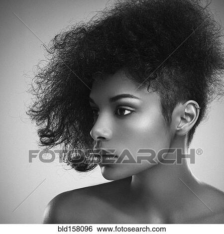 Stock Photograph - Close up of woman with curly hair. Fotosearch