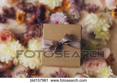 Close up of wrapped gift and flowers View Large Photo Image Stock Image - Close up of wrapped gift and flowers. Fotosearch