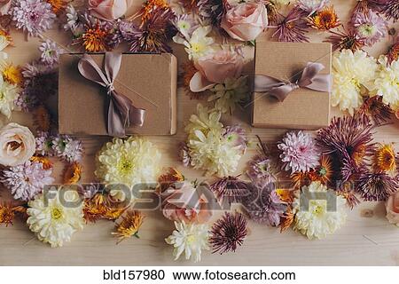 Stock Image - Close up of wrapped gifts and flowers. Fotosearch