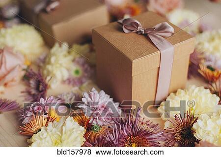 Stock Photo - Close up of wrapped gifts and flowers. Fotosearch