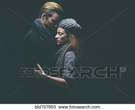 Couple wearing warm clothing hugging View Large Photo Image Stock Image - Couple wearing warm clothing hugging. Fotosearch