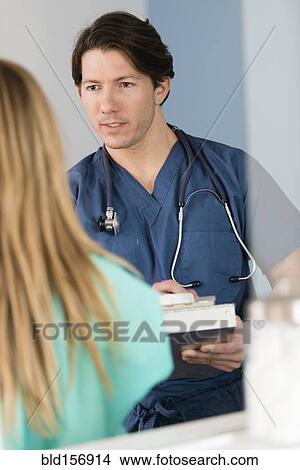 Picture - Doctor talking to patient. Fotosearch