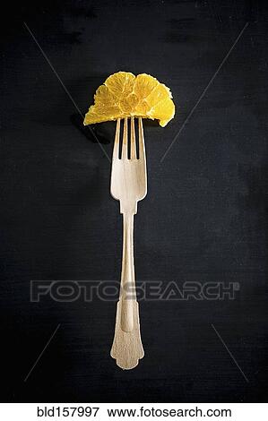 Fork with orange slice View Large Photo Image Stock Photo - Fork with orange slice. Fotosearch