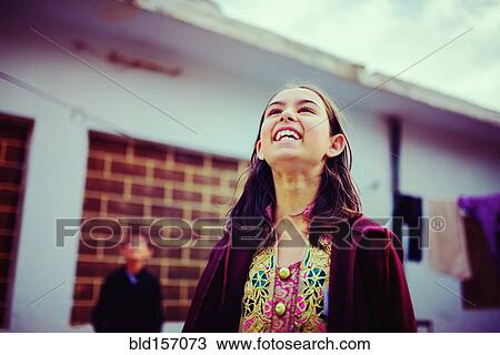 Stock Image - Girl looking up and laughing. Fotosearch