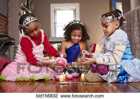 Girls playing dress-up at tea party View Large Photo Image Stock Image - Girls playing dress-up at tea party. Fotosearch