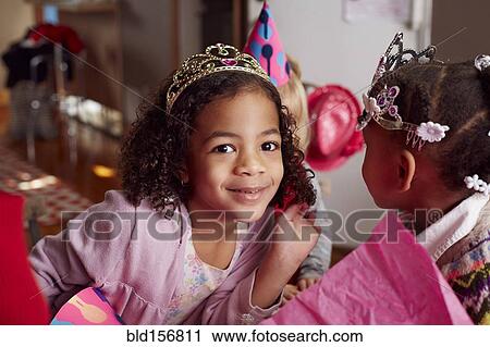 Girls wearing tiaras at party View Large Photo Image Stock Image - Girls wearing tiaras at party. Fotosearch