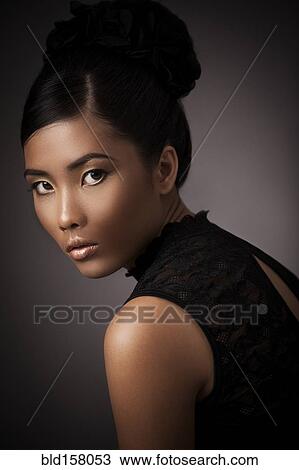 Glamorous woman looking over her shoulder View Large Photo Image Stock Image - Glamorous woman looking over her shoulder. Fotosearch