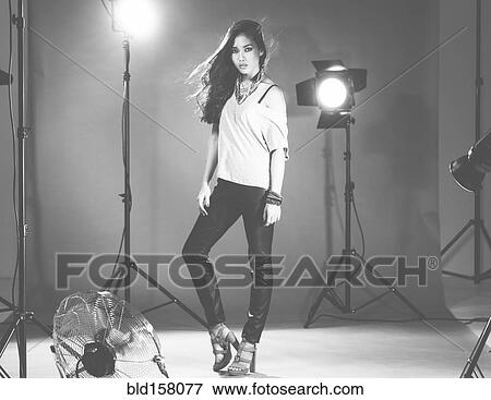 Stock Photo - Glamorous woman posing in photo shoot. Fotosearch