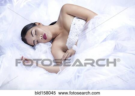 Glamorous woman sleeping in white gown View Large Photo Image Stock Photography - Glamorous woman sleeping in white gown. Fotosearch