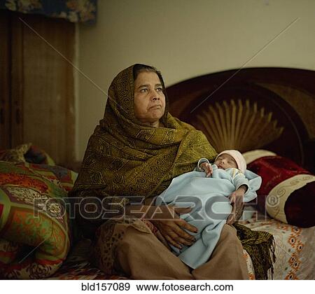 Grandmother holding baby grandson View Large Photo Image Stock Photo - Grandmother holding baby grandson. Fotosearch