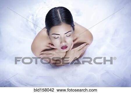 High angle view of glamorous woman wearing white gown View Large Photo Image Stock Image - High angle view of glamorous woman wearing white gown. Fotosearch