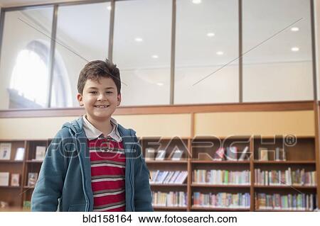 Hispanic boy smiling in library View Large Photo Image Picture - Hispanic boy smiling in library. Fotosearch