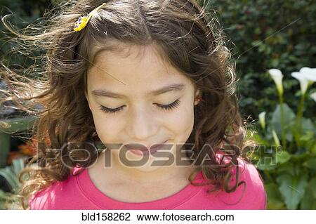 Hispanic girl smiling in garden View Large Photo Image Stock Image - Hispanic girl smiling in garden. Fotosearch