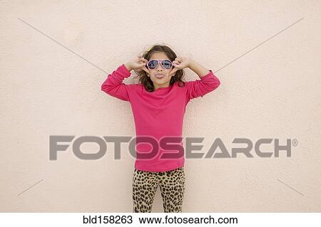 Hispanic girl wearing sunglasses and sticking out tongue View Large Photo Image Stock Image - Hispanic girl wearing sunglasses and sticking out tongue. Fotosearch