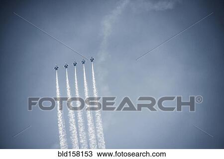 Jets flying in formation in cloudy blue sky View Large Photo Image Stock Image - Jets flying in formation in cloudy blue sky. Fotosearch