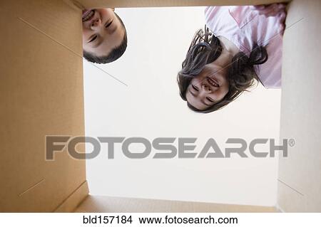 Low angle view of Asian brother and sister opening box View Large Photo Image Picture - Low angle view of Asian brother and sister opening box. Fotosearch