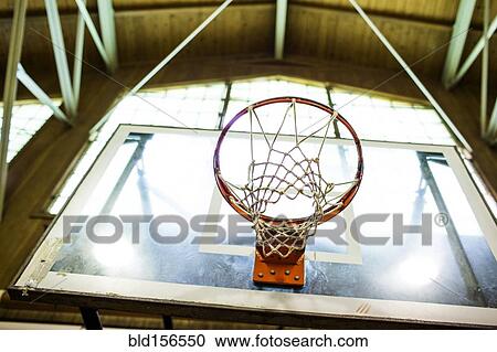 Stock Image - Low angle view of basketball hoop. Fotosearch