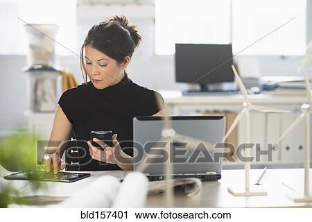 Mixed race architect with windmill models using digital tablet View Large Photo Image Stock Image - Mixed race architect with windmill models using digital tablet. Fotosearch