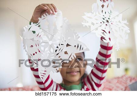 Mixed race girl holding paper snowflakes View Large Photo Image Stock Photography - Mixed race girl holding paper snowflakes. Fotosearch