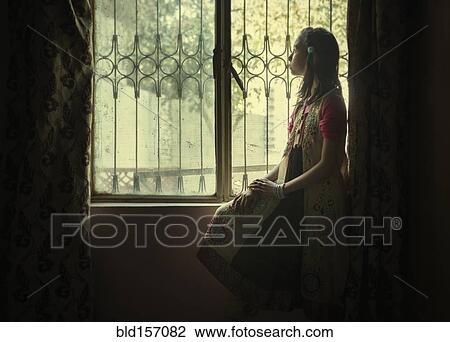 Mixed race girl looking out window View Large Photo Image Stock Image - Mixed race girl looking out window. Fotosearch