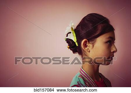 Picture - Mixed race girl wearing flowers in her hair. Fotosearch