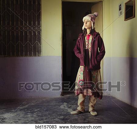 Stock Image - Mixed race girl wearing traditional clothing. Fotosearch