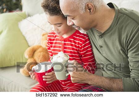 Mixed race grandfather and grandson drinking hot chocolate at Christmas View Large Photo Image Stock Image - Mixed race grandfather and grandson drinking hot chocolate at Christmas. Fotosearch