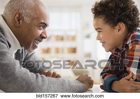 Mixed race grandfather and grandson having staring contest View Large Photo Image Stock Photo - Mixed race grandfather and grandson having staring contest. Fotosearch