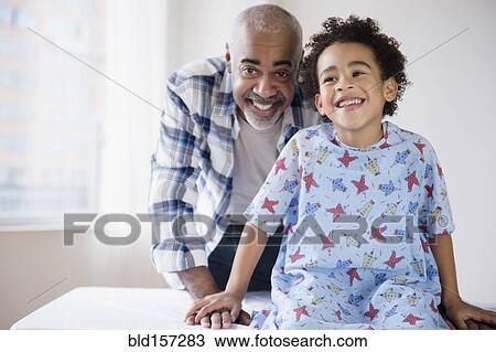Mixed race grandfather smiling with grandson in hospital View Large Photo Image Stock Image - Mixed race grandfather smiling with grandson in hospital. Fotosearch