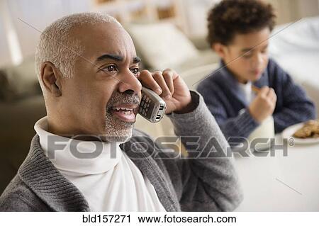 Mixed race man talking on telephone View Large Photo Image Stock Image - Mixed race man talking on telephone. Fotosearch