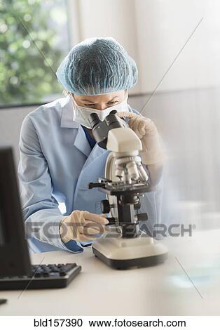 Mixed race scientist using microscope in laboratory View Large Photo Image Stock Image - Mixed race scientist using microscope in laboratory. Fotosearch