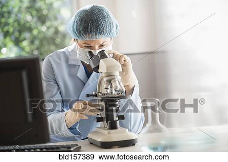 Mixed race scientist using microscope in laboratory View Large Photo Image Stock Photo - Mixed race scientist using microscope in laboratory. Fotosearch