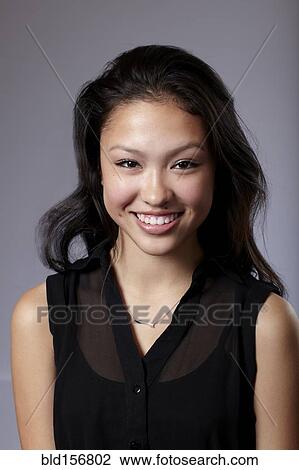 Mixed race teenage girl smiling View Large Photo Image Stock Image - Mixed race teenage girl smiling. Fotosearch