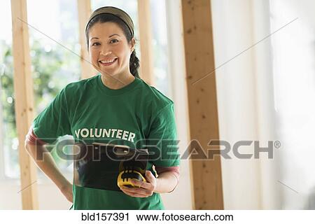 Mixed race volunteer helping build house View Large Photo Image Stock Image - Mixed race volunteer helping build house. Fotosearch