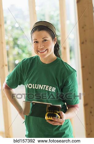 Mixed race volunteer helping build house View Large Photo Image Stock Image - Mixed race volunteer helping build house. Fotosearch