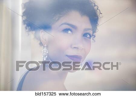 Mixed race woman wearing evening gown and earrings View Large Photo Image Stock Photography - Mixed race woman wearing evening gown and earrings. Fotosearch