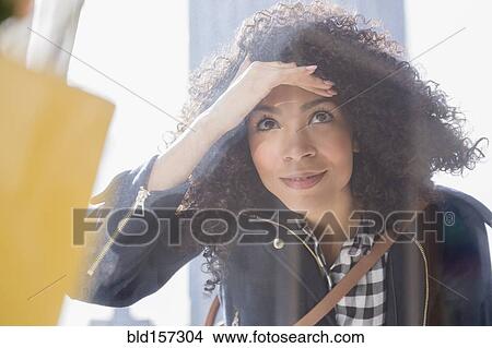 Mixed race woman window shopping View Large Photo Image Picture - Mixed race woman window shopping. Fotosearch