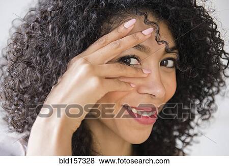 Stock Photo - Mixed race woman with curly hair smiling. Fotosearch