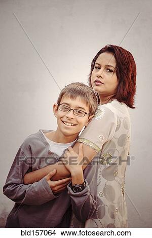 Picture - Mother and son hugging outdoors. Fotosearch