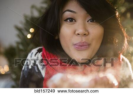 Pacific Islander woman blowing snow at Christmas View Large Photo Image Stock Photo - Pacific Islander woman blowing snow at Christmas. Fotosearch