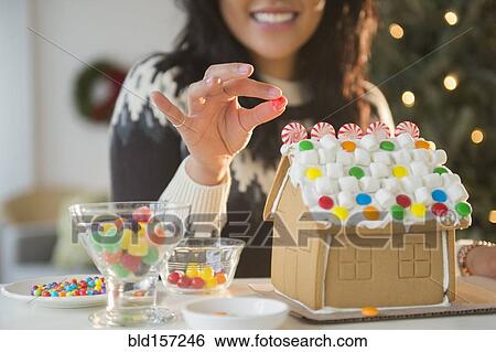 Pacific Islander woman decorating gingerbread house View Large Photo Image Stock Photograph - Pacific Islander woman decorating gingerbread house. Fotosearch
